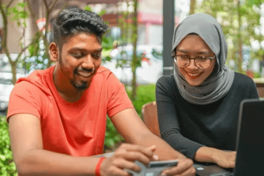 Photo of two students using computer
